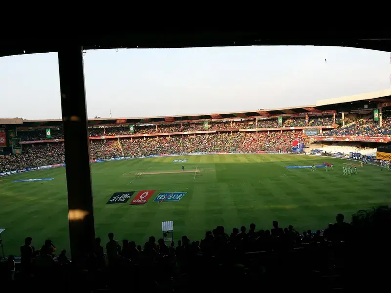 A cricket stadium in Bengaluru at dusk.