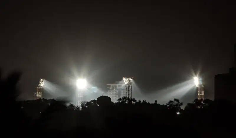 Stadium floodlights at night.